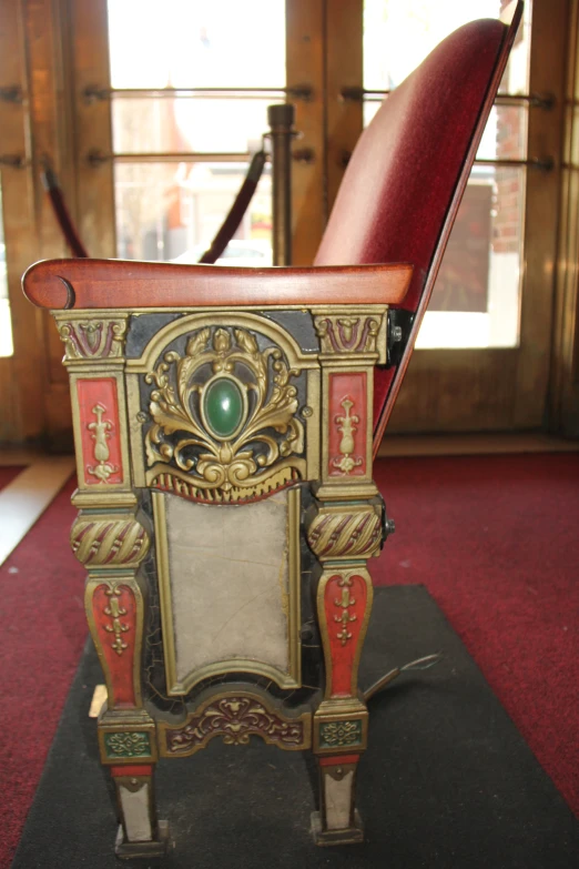 a chair with a green bead in its back