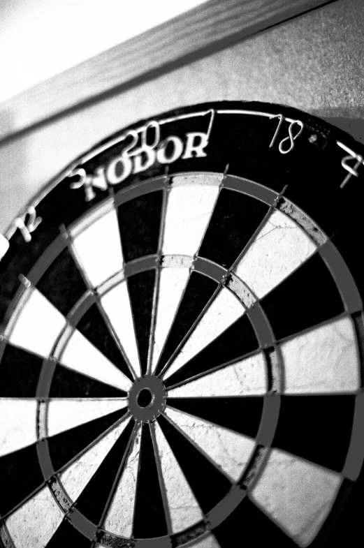 a dart board sitting on top of a wooden shelf