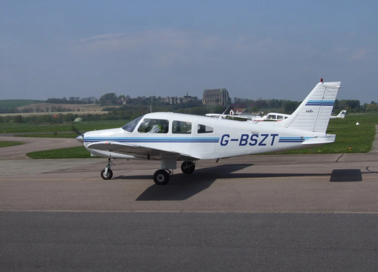 a white single engine plane sitting on top of a runway