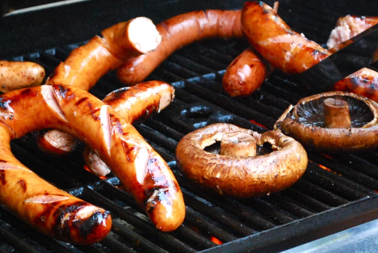 a couple of sausages sitting on top of a grill