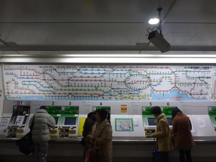 people are standing in line to check out the subway system