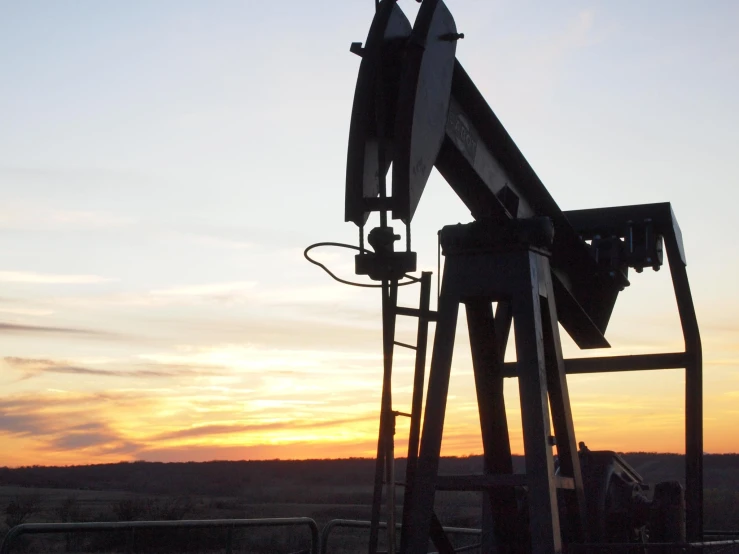 an oil well on an open field in the desert