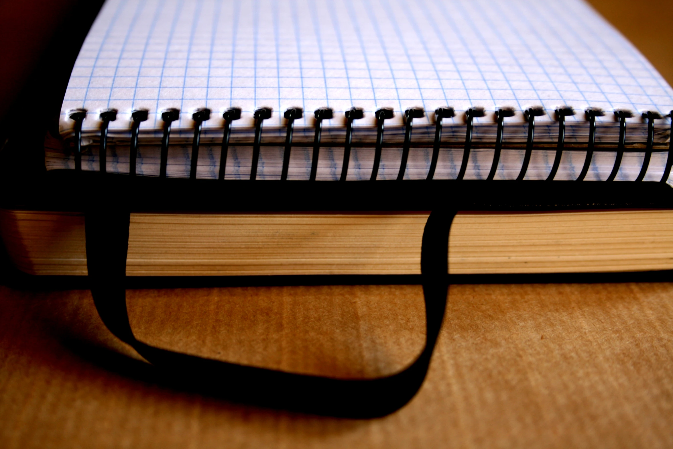 a black line notebook with an elastic loop