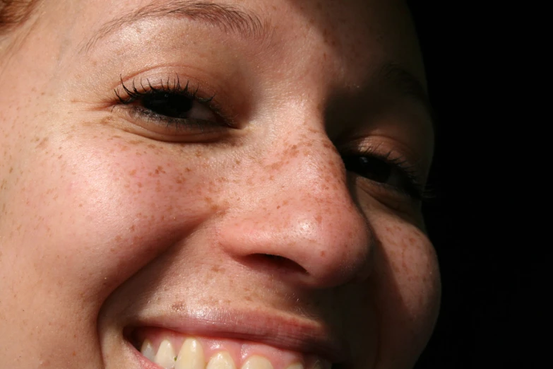 a woman smiling and showing her new toothbrush