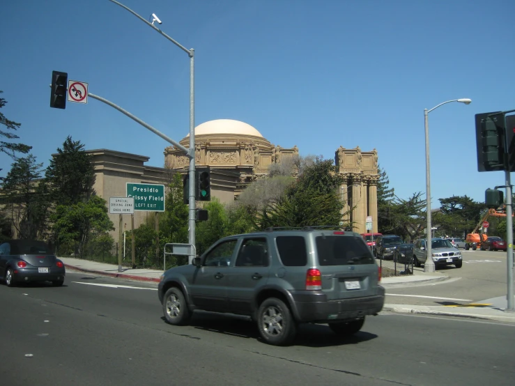 an suv is parked at the corner of a busy street