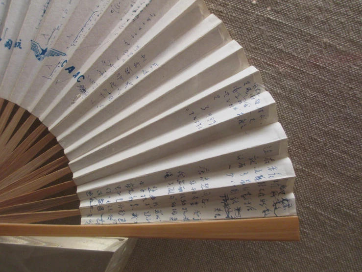 an oriental fan is shown with notes written on it