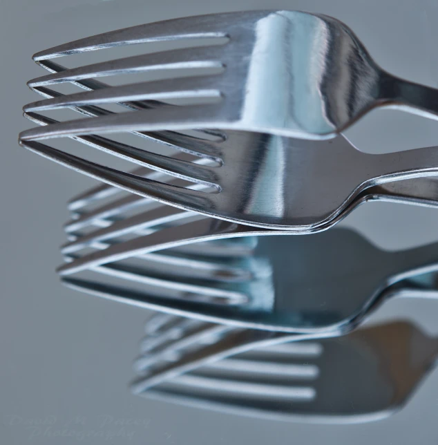 closeup of a fork with an extra set of forks next to it