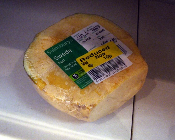 close up of a piece of cheese with a price tag