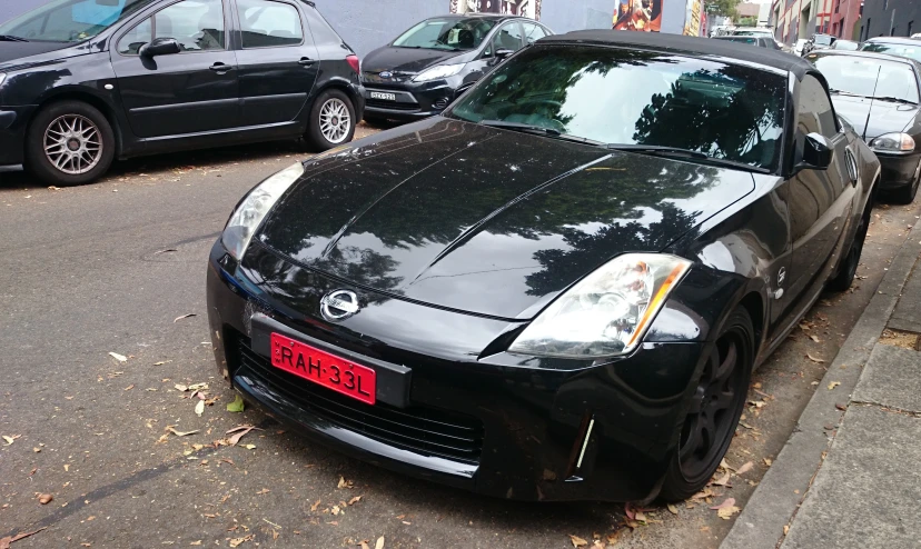 a very big pretty black sports car in a parking lot