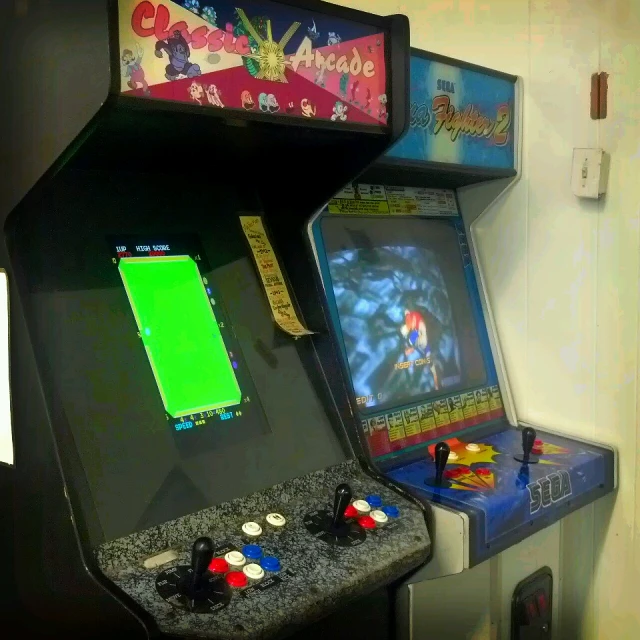 a couple of arcades sitting on top of a wooden table