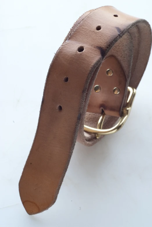a leather belt with a metal buckle hanging off of it