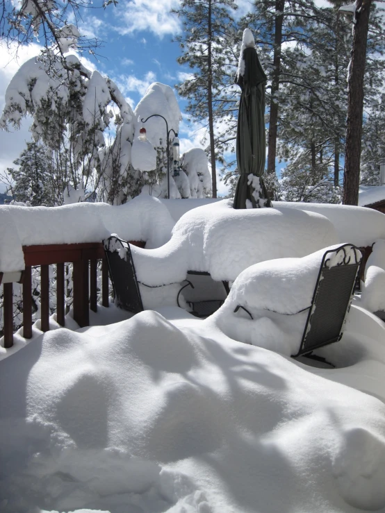 a bench on a covered deck with white snow