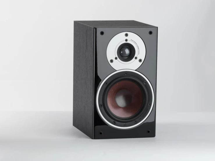 a speaker sitting on top of a white surface