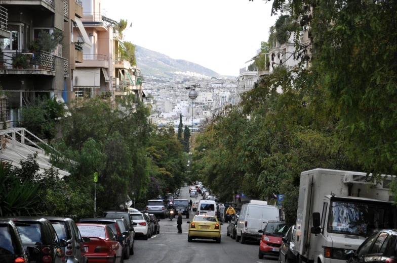 cars are lined up along the street in this town