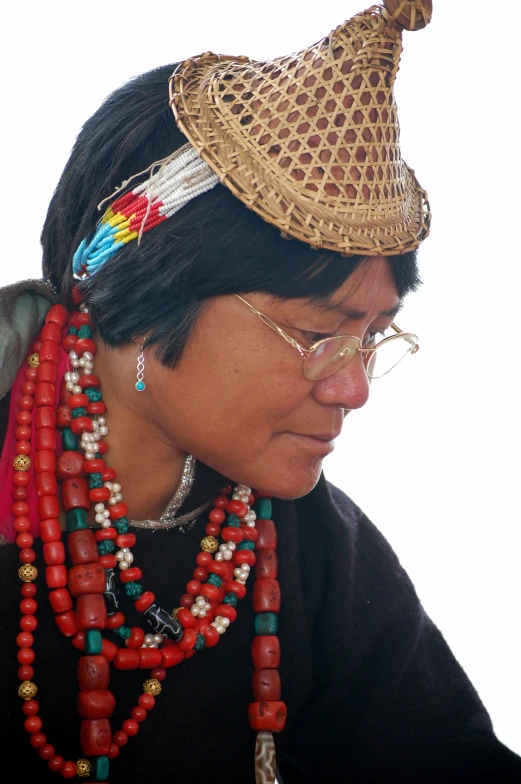 the woman wears a red, green, and yellow necklace