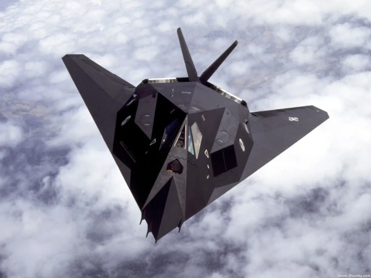 the fighter jet is flying in front of the clouds