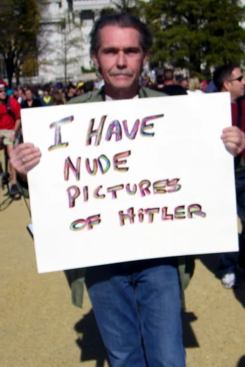 a man is holding a sign outside