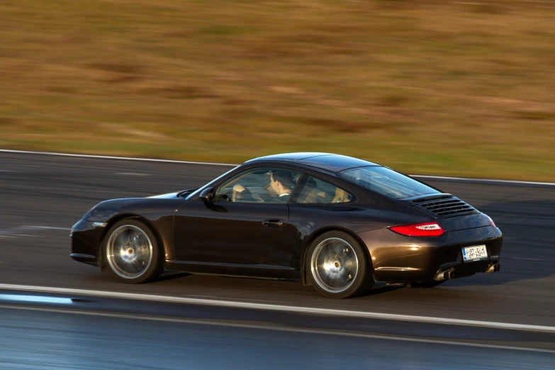 a porsche convertible sports car with a driver