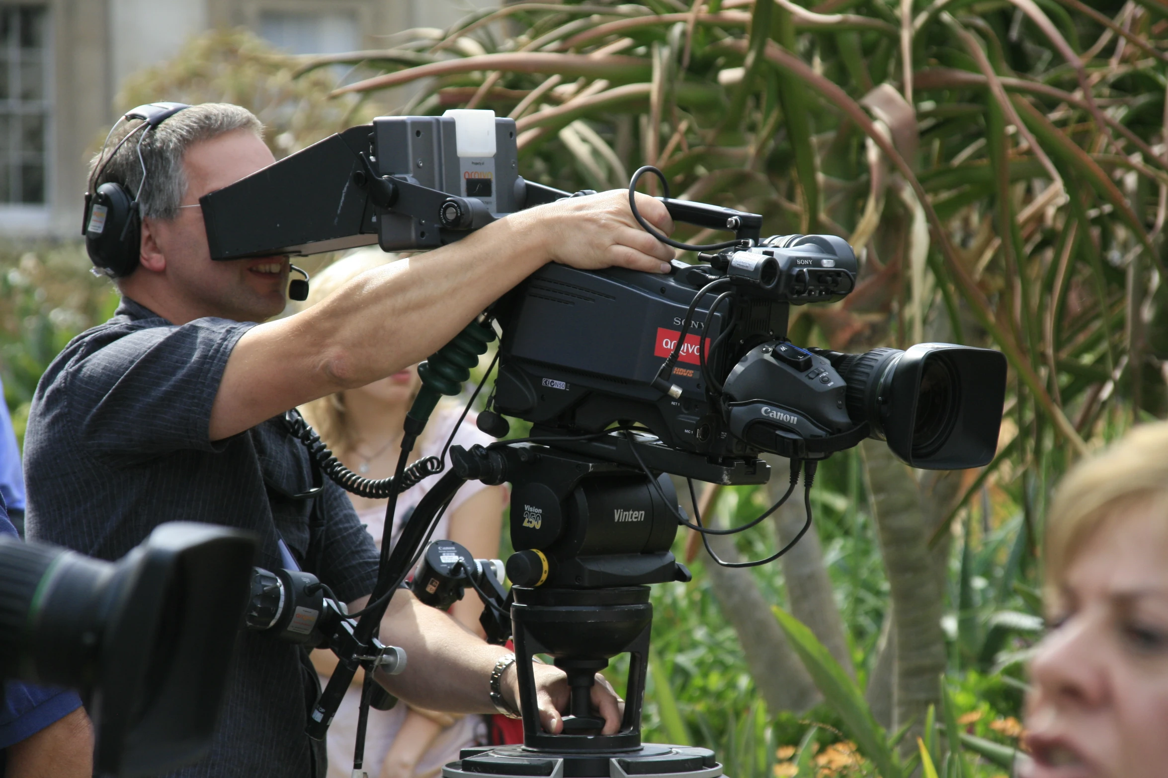 a man recording on a camera with headphones