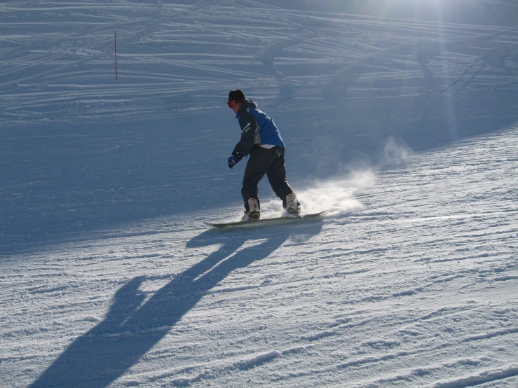 a person is snowboarding on a snowy slope