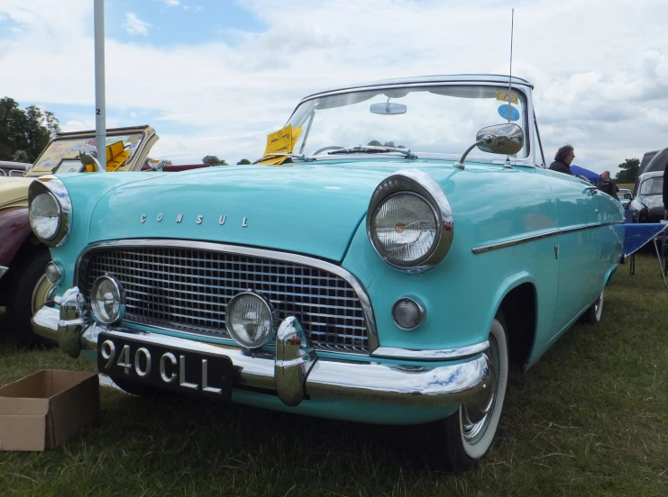 a blue car is parked on a field