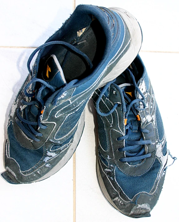 a pair of blue shoes with white and black laces on the bottom