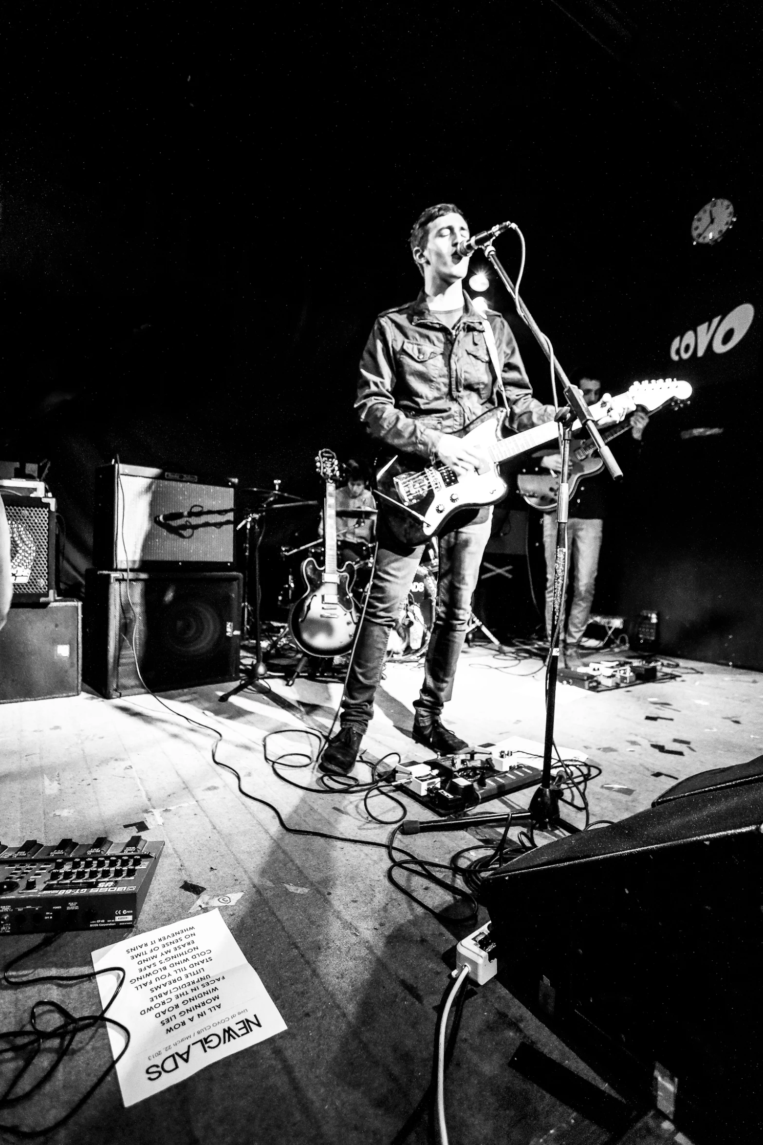 man playing guitar in the middle of a stage