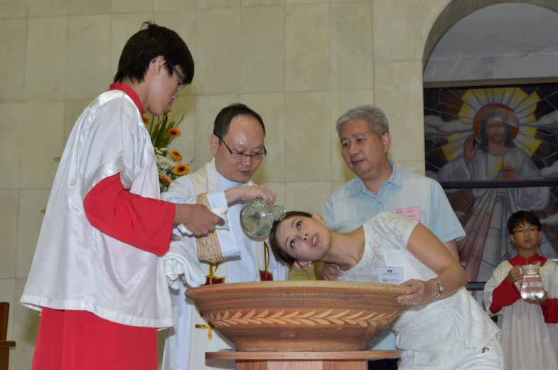 a woman is dressed up in white with her priest