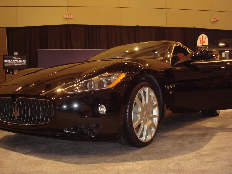 a fancy black sports car is shown parked