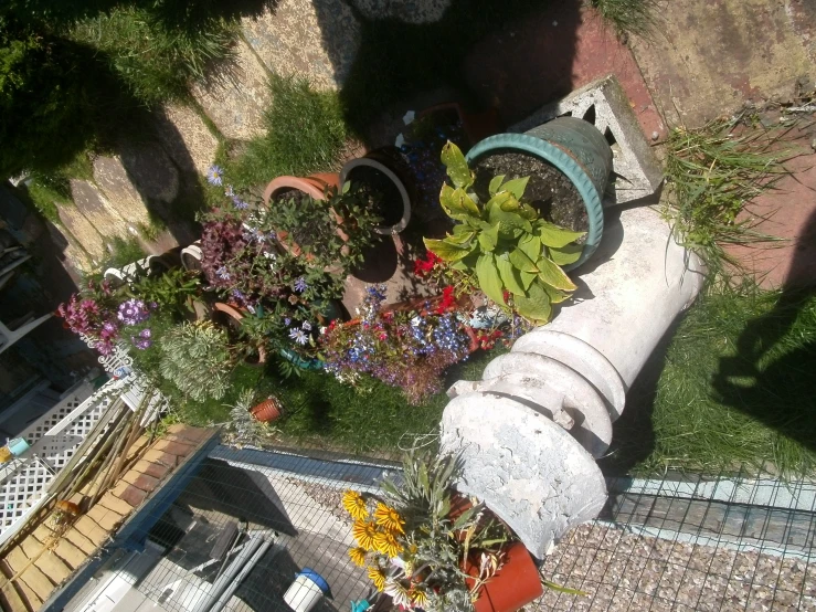 an aerial view of a building, from above, with flowers in the foreground