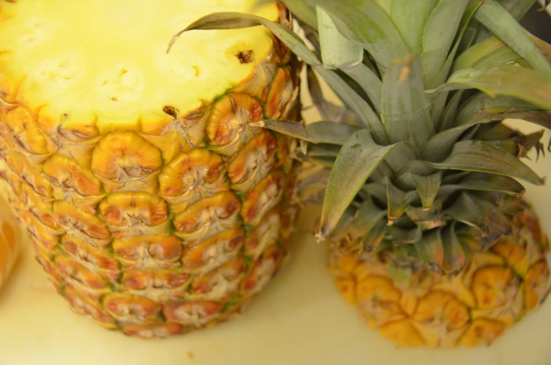 a close up view of two yellow pineapples