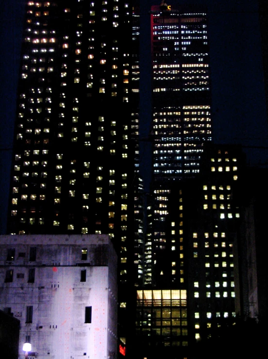 an urban view is lit up with buildings and a clock