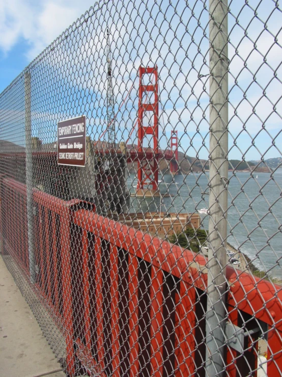 a red object is on the road by the water