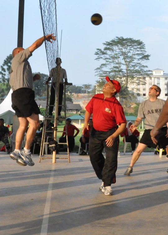 some young men playing with a volleyball net