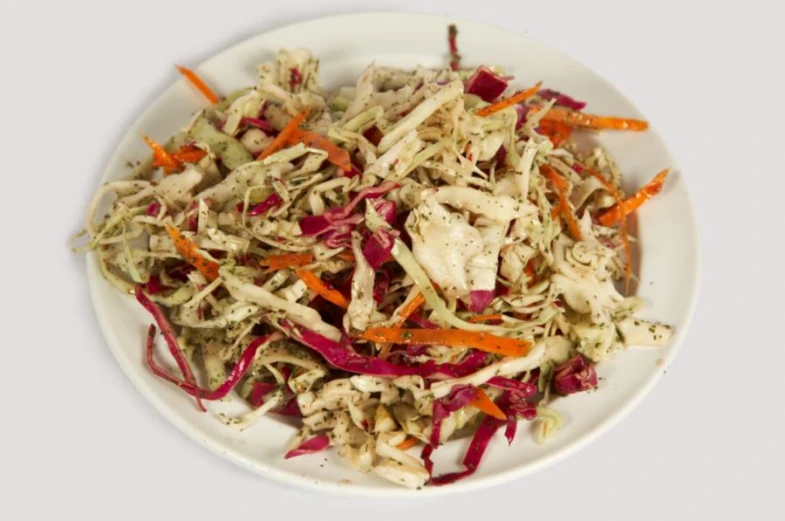 shredded vegetables on a plate on a white background