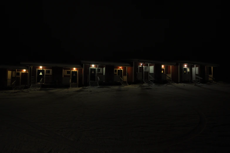 two small buildings are lit up in the dark