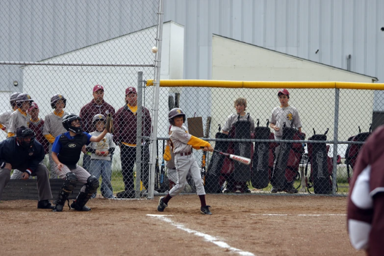 a child is at bat ready to hit a ball