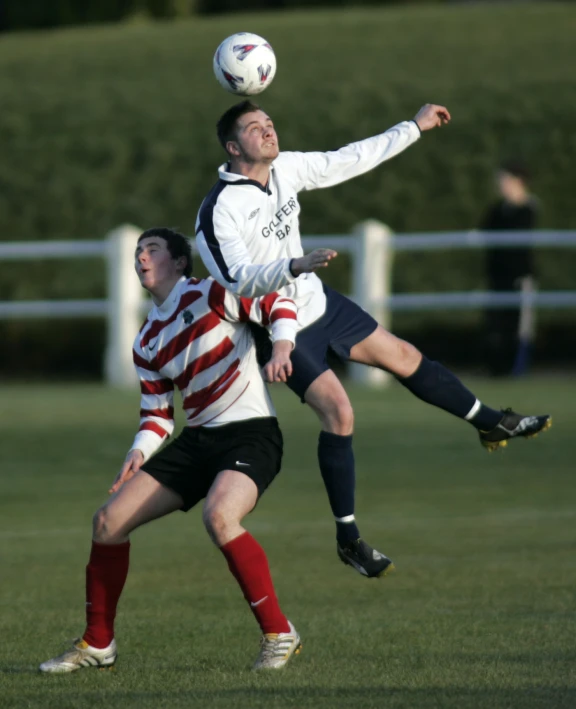 two players compete for the ball during a soccer game