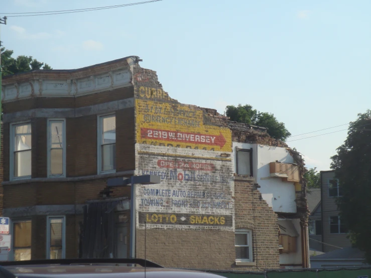 a big brick building with a lot of signs on the side