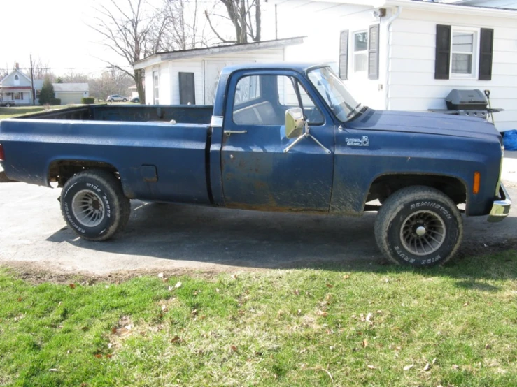 a small pick up truck parked in a driveway