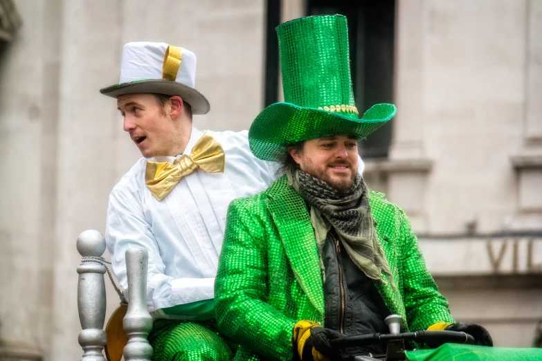 a man in green pants and top hat on a carriage