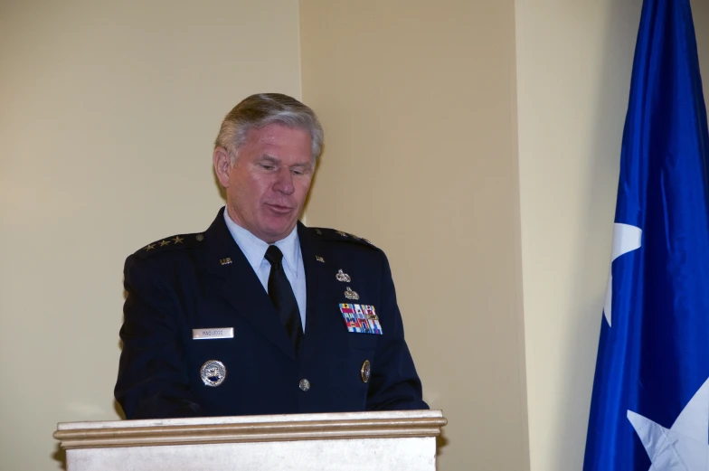 a man in military fatigues giving a speech