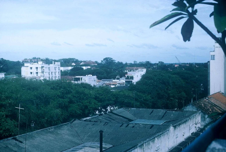 a small building sits next to a very large city