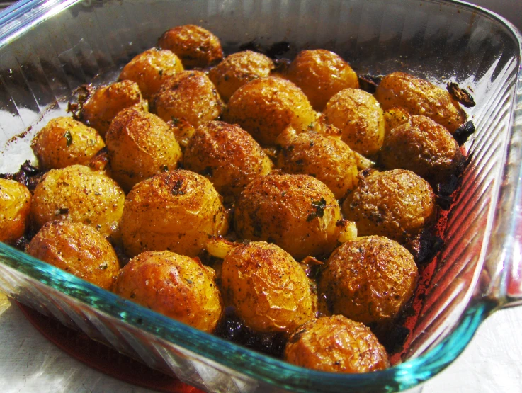 a square dish filled with small, fried food items