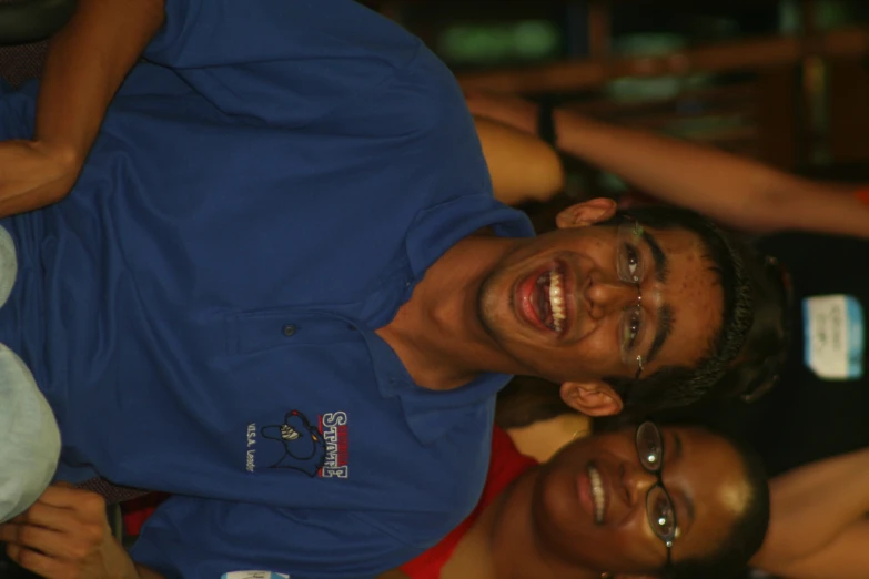 two smiling men sitting next to each other