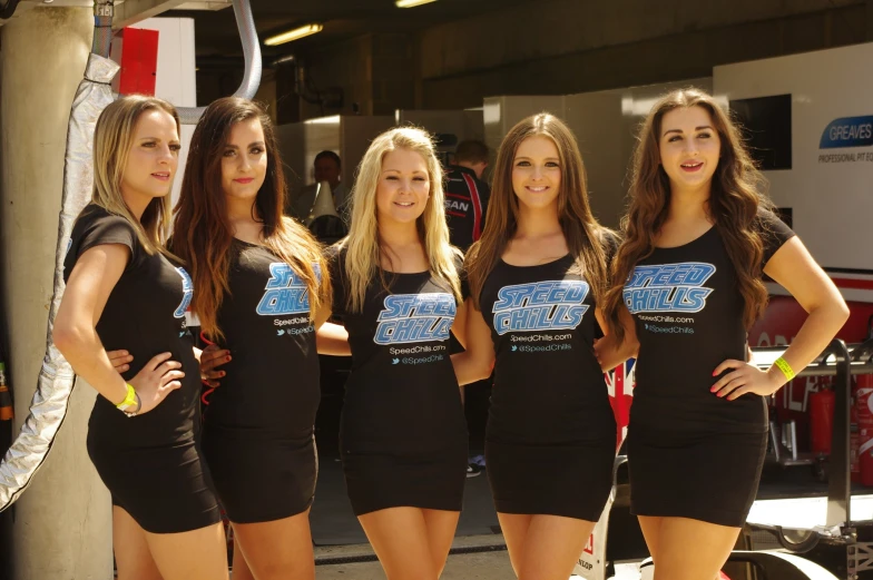 four female racing drivers posing for a picture