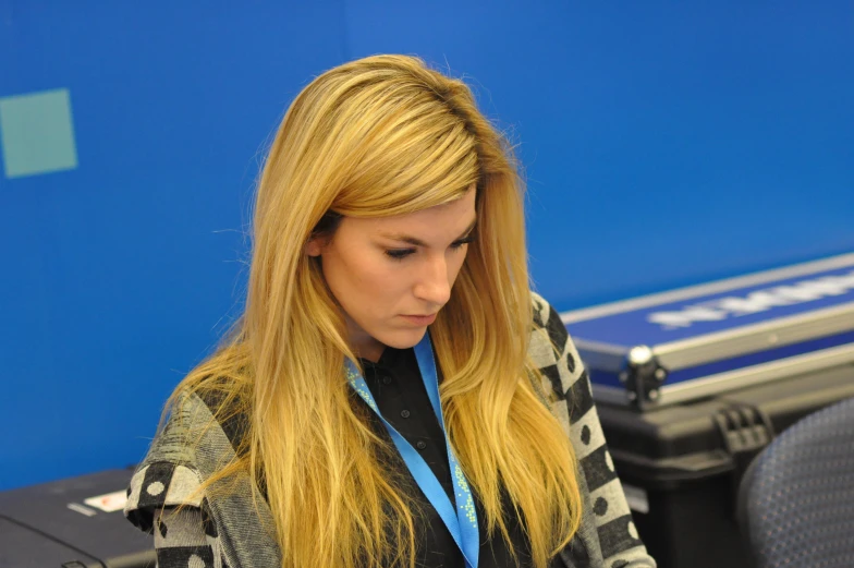 a woman looks down at her cell phone