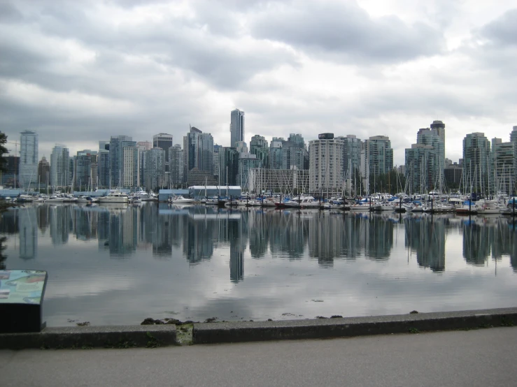 a cityscape that includes the harbor with sailboats