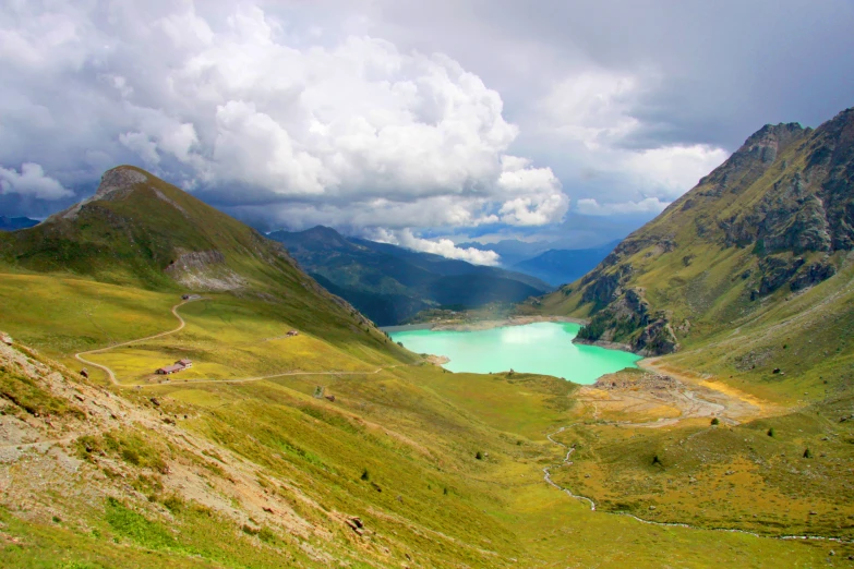 there is a bright green lake in the mountains