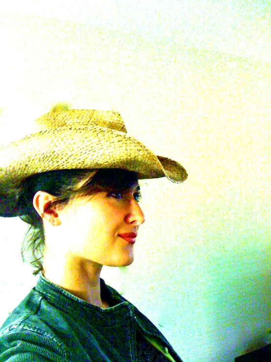 woman with hat and blue jeans looking over shoulder